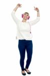 Joyous Middle Aged Woman Dancing To The Beat Stock Photo