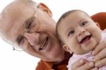 Smiling Grandpa And Baby Stock Photo