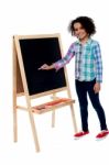 Charming Young Girl Writing On Blackboard Stock Photo