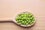 Peas On Wooden Spoon Stock Photo