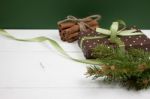 Polka Dot Gift With Christmas Decoration With Cinnamon And Pine Branches On White Wood Background Stock Photo