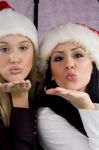 Women Giving Christmas Kiss Stock Photo