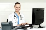 Female Doctor Working On Computer Stock Photo