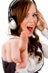 Sidepose Of Female Holding Headphone And Pointing Stock Photo