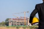 The Arms Of A Male Businessman Holding A Helmet Stock Photo