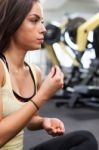 Happy Woman Having A Break From Exercising In Health Club Stock Photo