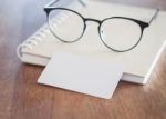 Blank Business Cards And Eyeglasses On Wooden Table Stock Photo