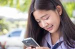 Portrait Of Thai Student Teen Beautiful Girl Using Her Phone And Smile Stock Photo