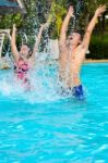 Father And Daughter Have Fun In The Pool Stock Photo