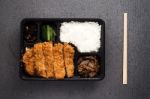 Japanese Food Tonkatsu Rice And Vegetable Take Away On Table Background Stock Photo