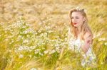 Blond Girl On The Camomile Field Stock Photo