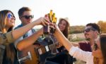 Portrait Of Group Of Friends Toasting With Bottles Of Beer Stock Photo