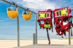 Safety Helmets And Life Jackets Hanging On Railing Stock Photo