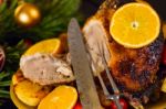 Christmas Baked Duck Served With Potatoes, Orange And Tomatoes Stock Photo