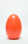 Red Plastic Egg On White Table Stock Photo