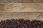 Coffee Beans On Grain Wood Stock Photo