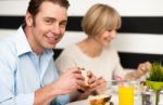 Couple Enjoying Delicious Breakfast Stock Photo