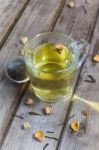 Mug Of Flavored Green Tea With Rose Buds And Petals Stock Photo