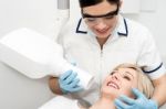 Female Dentist Using X-ray Machine Stock Photo