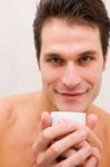 Smiling Young Man Holding Cup Stock Photo