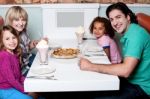 Family Of Four Posing To Camera Stock Photo