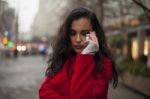 Sad Woman In Red Coat Hold On Mobile Phone, Smartphone, Urban Sc Stock Photo