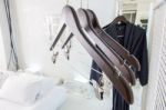 Wooden Cloth Hangers On Clothes Rail And Bathrobe Stock Photo