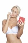 Young Woman Clean Face With Wet Wipes And Holding Mirror Stock Photo