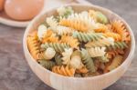 Fusili Pasta In Wooden Plate With Eggs Stock Photo