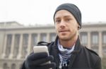 Man With Mobile Phone In Hands Stock Photo