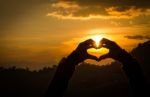 Silhouettes Hand Heart Shaped With Sun Sets Stock Photo