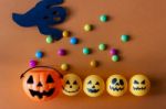 Halloween Jack O Lantern Bucket With Candies On Orange Backgroun Stock Photo