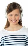 Smiling Girl Enjoying Music Stock Photo