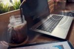 Double Exposure Of Computer On The Table Inside Coffee Shop Stock Photo