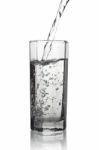 Water Pouring Into A Tall Glass With Its Reflection, Closeup Vie Stock Photo