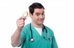 Doctor Holding Condom Over White Stock Photo