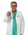 Senior Doctor holding Stethoscope Stock Photo