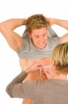 Woman Measuring Chest Of Young Man Stock Photo