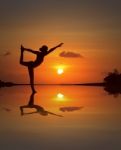 Silhouette Woman Doing Yoga Stock Photo