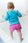 Baby Girl Learning To Walk At Home Stock Photo