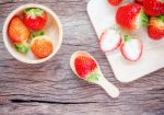 Bowl With Fresh Strawberries On An Old Wooden Table Stock Photo