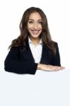 Female Executive Behind Blank White Ad Board Stock Photo