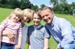 Beautiful Happy Family Enjoying At The Park Stock Photo