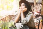 Woman Drinking Coffee In The Garden Outdoor In Sunlight Light En Stock Photo