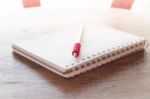 Work Station With Notebook And Pencil With Vintage Filter Stock Photo