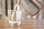 Pour Milk From A Pitcher Into A Glass Stock Photo