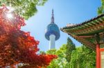 Seoul Tower With Gyeongbokgung Roof And Red Autumn Maple Leaves At Namsan Mountain In South Korea Stock Photo