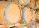 Round Wooden Wine Barrels In Cellar Shelf Stock Photo