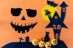 Halloween Concept With Black Eyes And Mouth On Orange Background Stock Photo