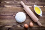 Raw Pizza Dough And Rolling Pin On Wooden Background Stock Photo